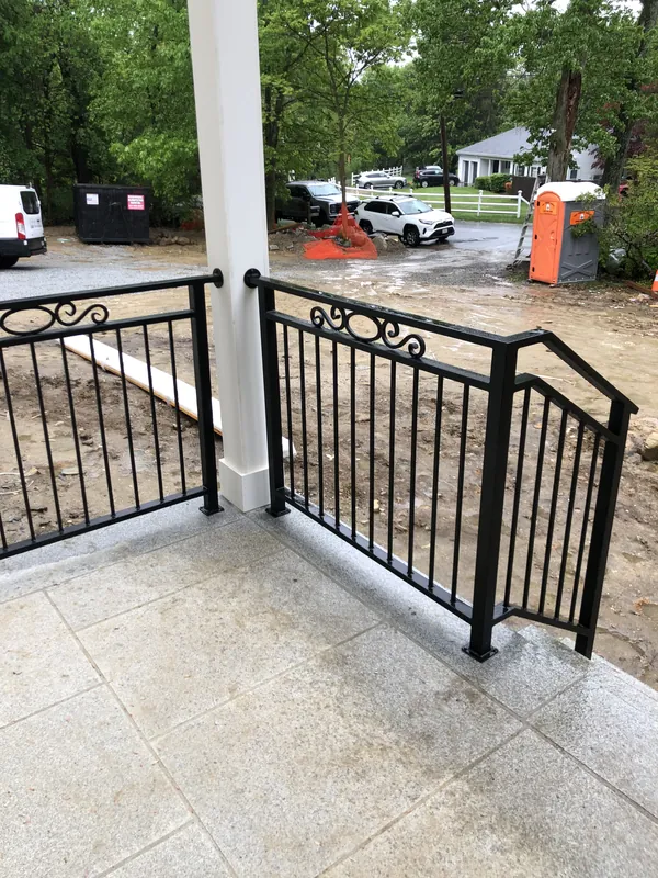 Black porch and stair railing with decorative circular details